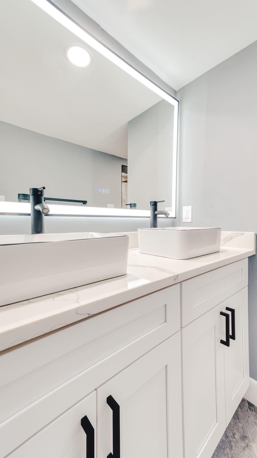 Master bathroom remodel with double vessel sinks and LED mirror in Altamonte Springs, FL