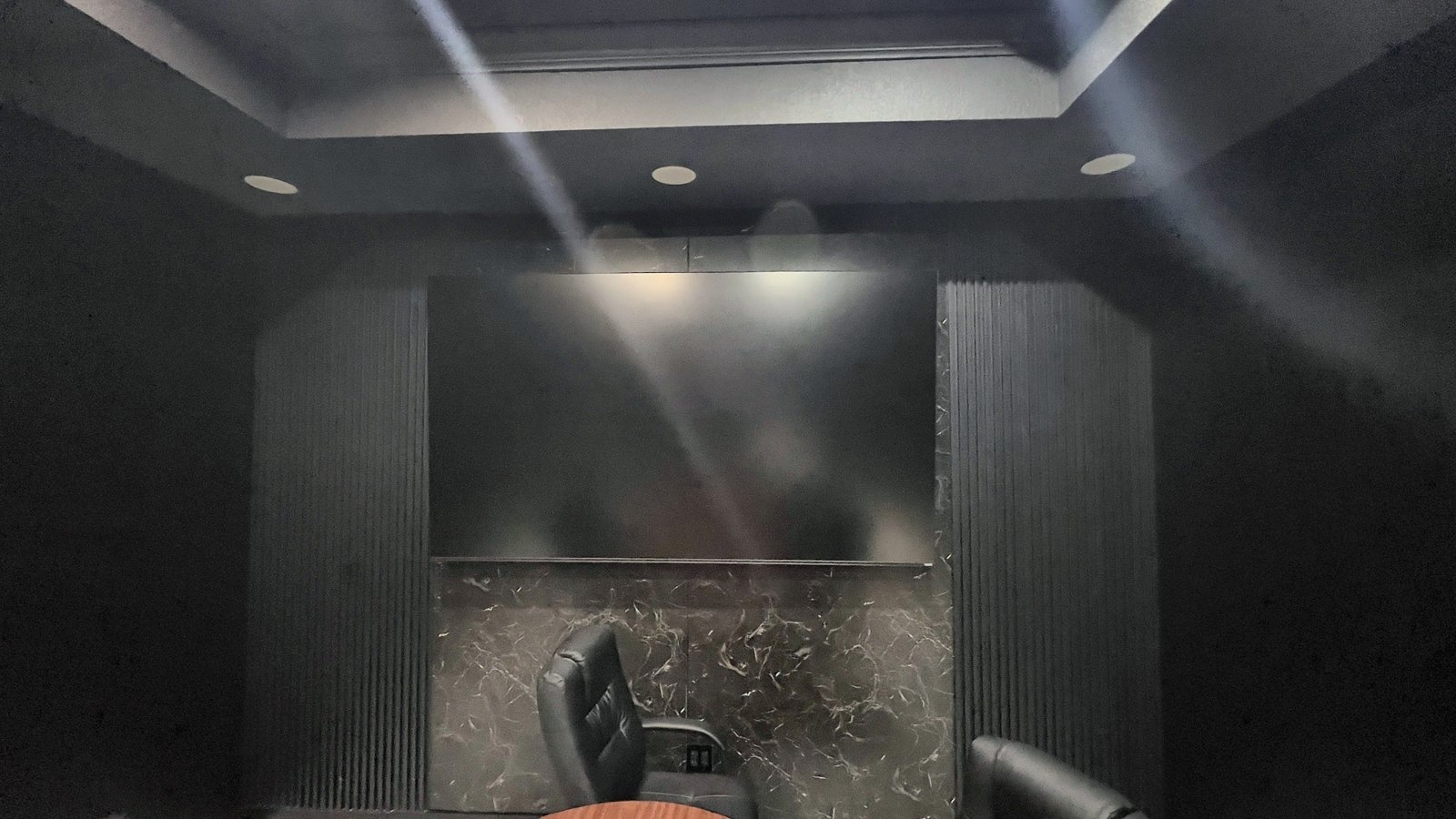 Conference room TV wall with marble panel and slat-wall surround — Lake Mary FL commercial remodel