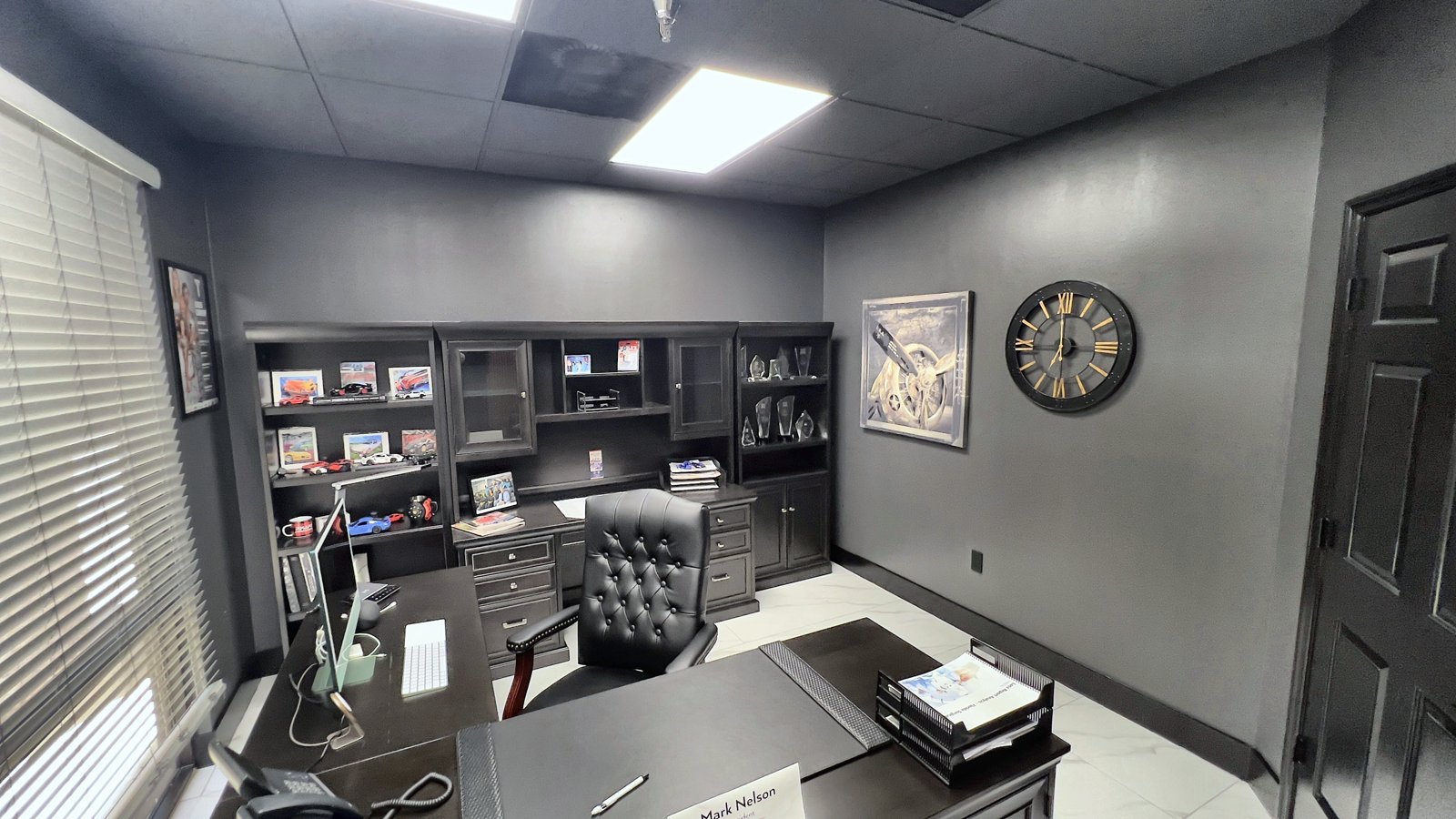 After: private office remodel with dark built-in cabinetry and new lighting — Lake Mary FL tenant improvement