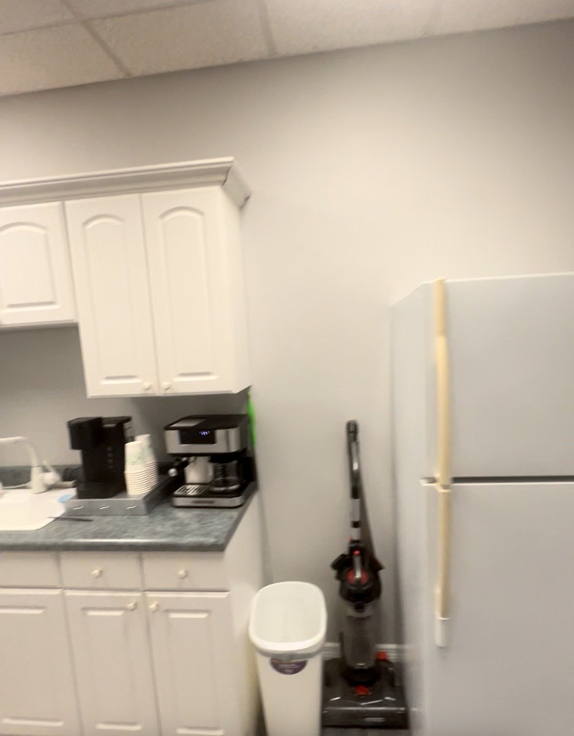 Before: dated office break room with white cabinets and laminate counter, Lake Mary FL