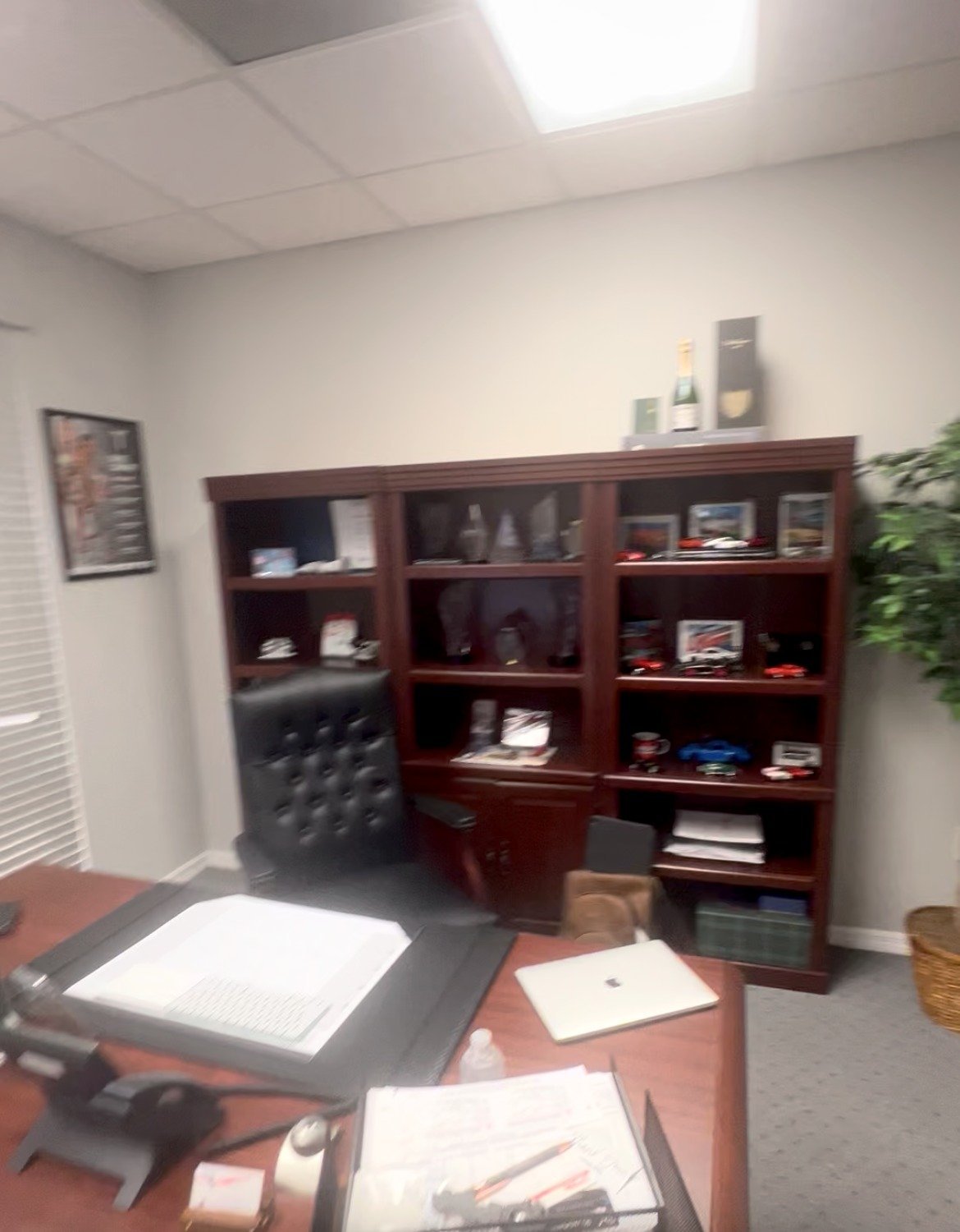 Before: private office with cherry bookcase and gray carpet prior to remodel