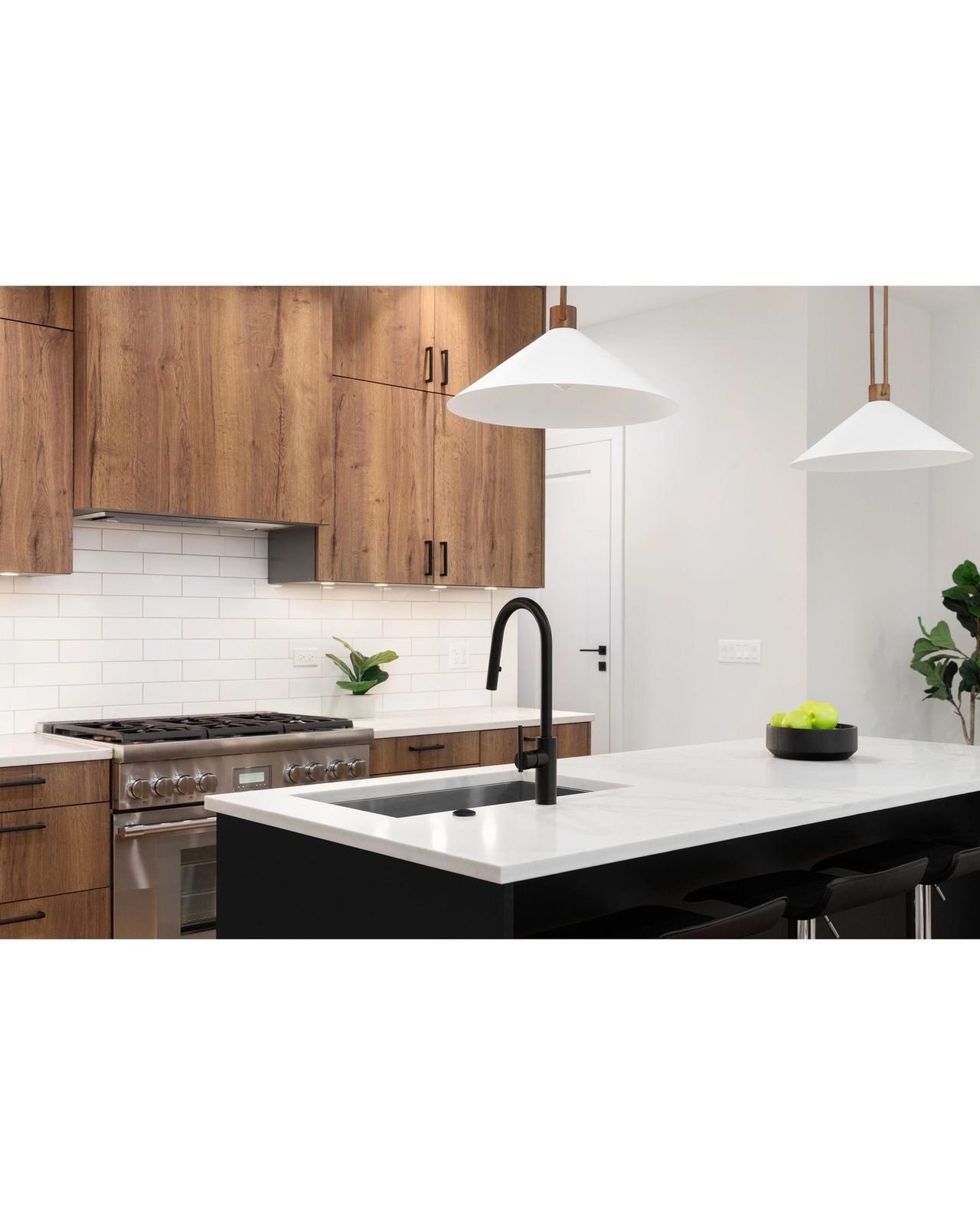 Custom wood cabinetry and matte black fixture detail from a Kaplan kitchen remodel
