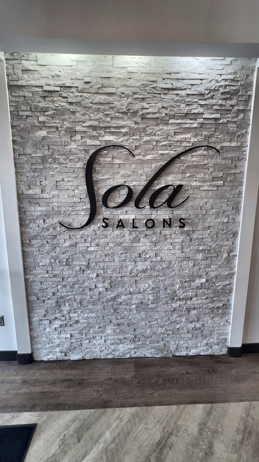 Sola Salons commercial renovation in Altamonte Springs FL — stone entry feature wall